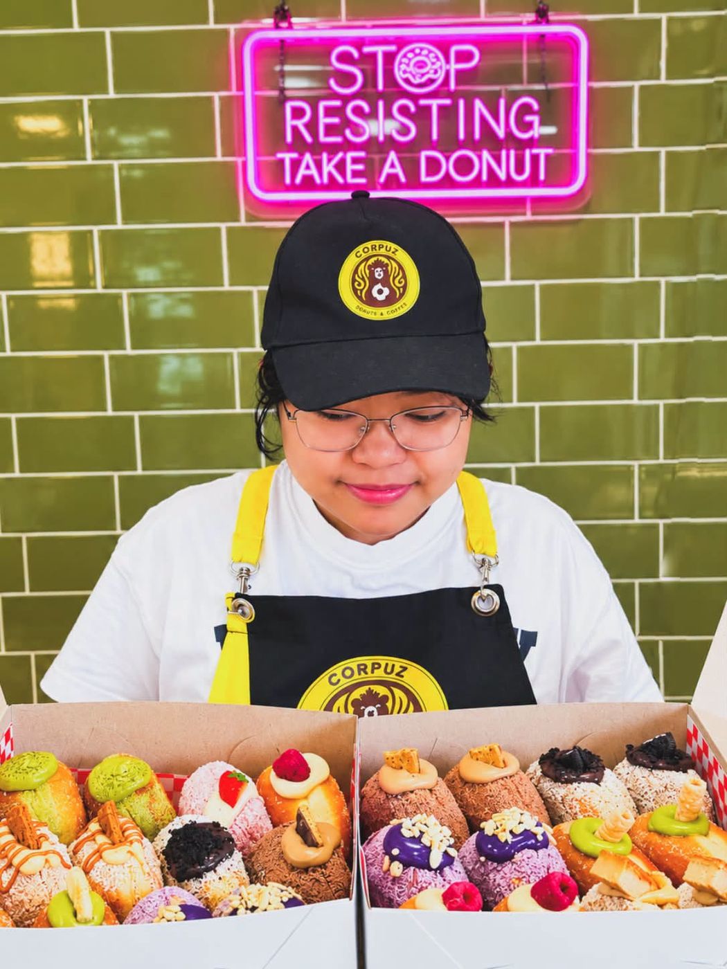 Boxes of donuts under the neon sign